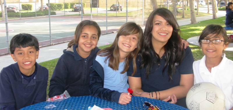 People Gathered Around a Table Outdoors